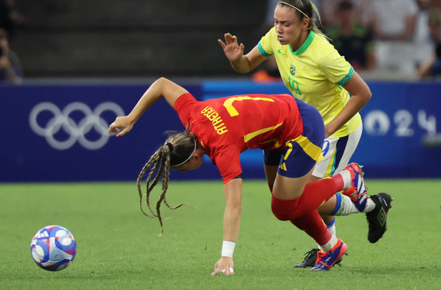 Spain's forward #07 Athenea Del Castillo falls next to Brazil's forward #19 Priscila in the women's semi-final football match between Brazil and Spain during the Paris 2024 Olympic Games at the Marseille Stadium in Marseille on August 6, 2024. (Photo by Pascal Guyot/AFP Photo)