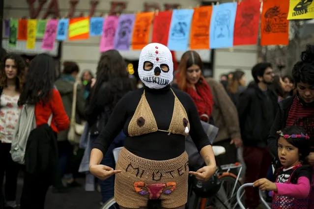 A demonstrator poses for a picture during a rally held to support women's rights to an abortion in Santiago, Chile, July 25, 2015. The word on her costume reads, “Woman”. (Photo by Ivan Alvarado/Reuters)