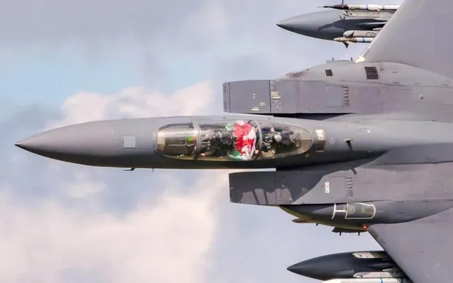 A US Air Force F15e “strike eagle” fighter jet, based at RAF Lakenheath, Suffolk, flies the Welsh flag in the cockpit, as the plane flies at speeds of up to 600mph, through the valleys in the Snowdonia national park, North Wales, England on July 30, 2019. (Photo by Wayne Lewis/South West News Service)
