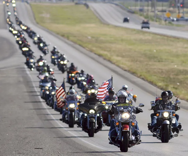 Hundreds of motorcyclists make their way on Highway 191 toward Odessa, Texas on their way to Andrews Monday morning, May 29, 2017 during the Memorial Day Ride to Remember. The ride begins with a ceremony at the Permian Basin Vietnam Memorial and ends with a wreath ceremony at the Andrews War Memorial. (Photo by Mark Sterkel/AP Photo/Odessa American)