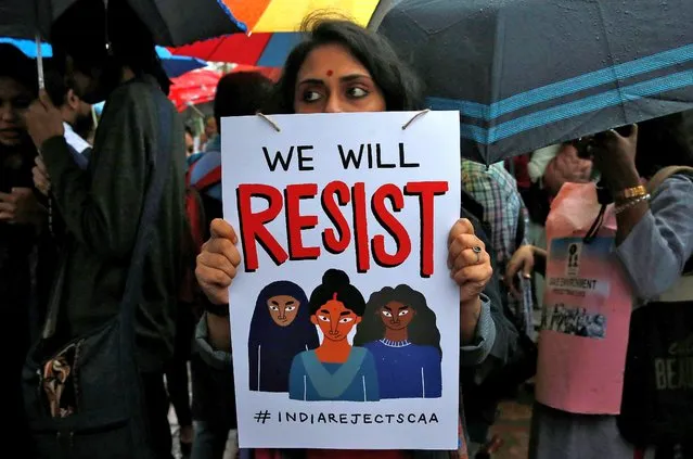A demonstrator displays a placard as she attends a protest rally against a new citizenship law, in Kolkata, India, January 3, 2020. (Photo by Rupak De Chowdhuri/Reuters)
