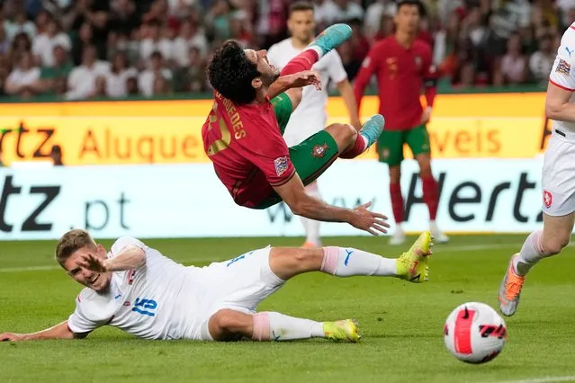 Portugal's Gonçalo Guedes, right, is tackled by Czech Republic's Michal Sadilek during the UEFA Nations League soccer match between Portugal and the Czech Republic, at the Jose Alvalade Stadium in Lisbon, Thursday, June 9, 2022. (Photo by Armando Franca/AP Photo)