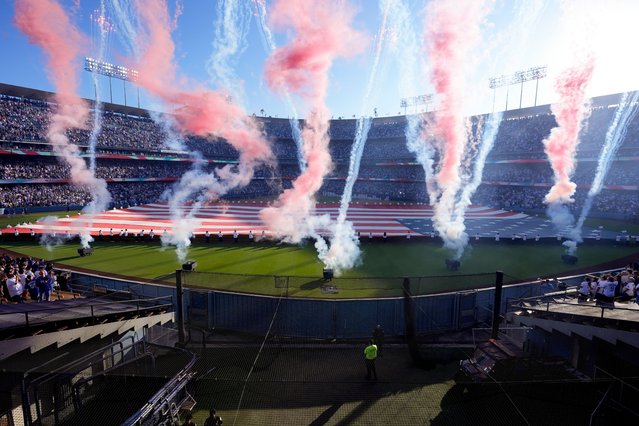 Fireworks fill the air as the national anthem plays before game 1 of a baseball NL Championship Series between the Los Angeles Dodgers and the New York Mets, Sunday, October 13, 2024, in Los Angeles. (Photo by Mark J. Terrill/AP Photo)