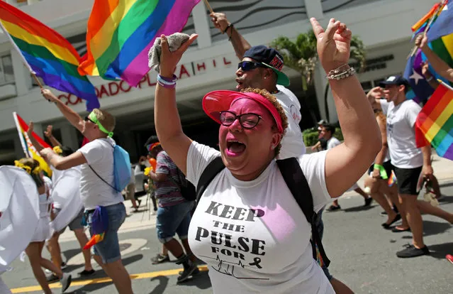 A participant wears a shirt printed with a tribute to the victims of the shooting at the Pulse night club in Orlando, during the annual gay pride parade in San Juan, Puerto Rico, June 26, 2016. (Photo by Alvin Baez/Reuters)
