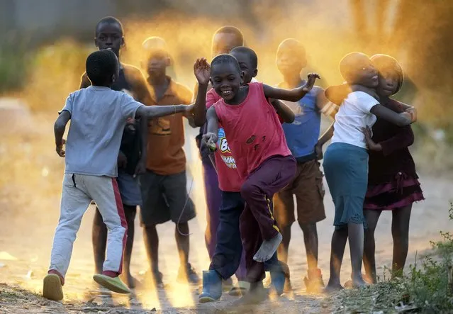 Children play on the dusty streets of Epworth, a poor neighbourhood on the outskirts of Harare, Zimbabwe, Wednesday, June, 15, 2022. (Photo by Tsvangirayi Mukwazhi/AP Photo)