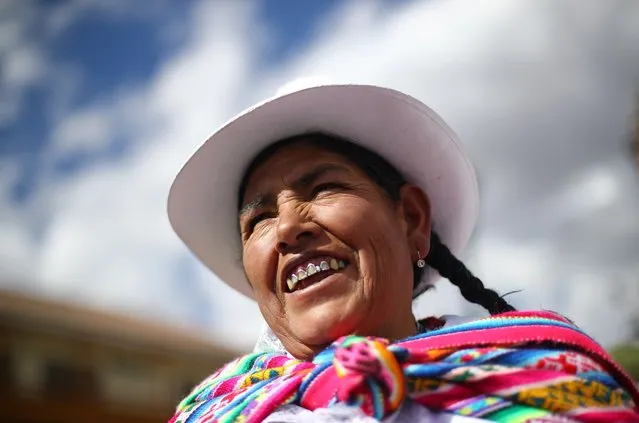 A woman wearing traditional clothes smiles during the parade of saints in the central square of Cusco ahead of the celebration of the Inti Raymi Sun Festival on June 23, 2022 in Cusco, Peru. Inti Raymi Sun Festival is held every year following the Inca tradition to mark the winter solstice in the Southern Hemisphere and pay tribute to the sun. (Photo by Leonardo Fernandez/Getty Images)