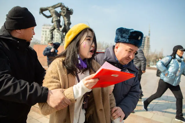 Kyrgyz law enforcement officers detain a women's rights activist during a rally on International Women's Day in Bishkek, Kyrgyzstan on March 8, 2020. (Photo by Gulzhan Turdubaeva/Radio Free Europe/Radio Liberty)