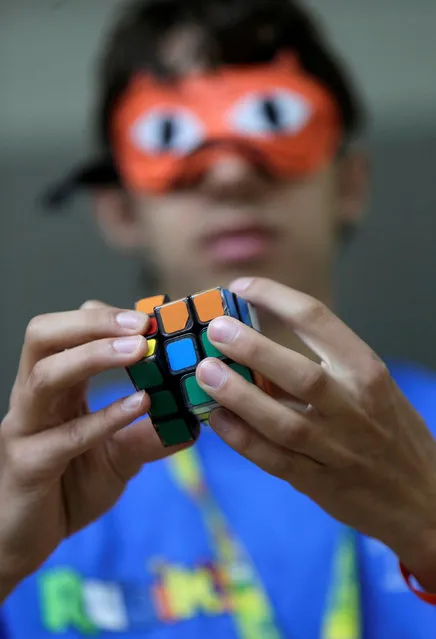 A blindfolded competitor solves a Rubik's cube as he prepares for the Rubik's Cube European Championship in Prague, Czech Republic, July 15, 2016. (Photo by David W. Cerny/Reuters)