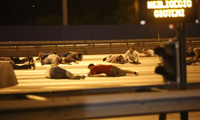 People take cover on the Bosphorus bridge in Istanbul on July 16, 2016. (Photo by SIPA Press/Rex Features/Shutterstock)