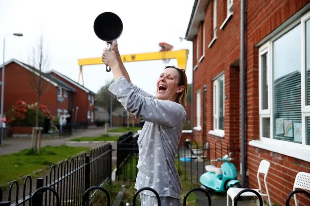 People react during the Clap for our Carers campaign in support of the NHS while the spread of the coronavirus disease (COVID-19) continues, in Belfast, Northern Ireland, April 9, 2020. (Photo by Jason Cairnduff/Reuters)