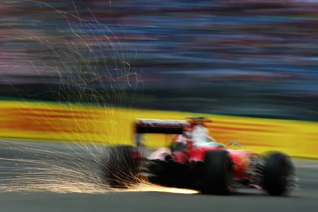 Sparks fly behind Sebastian Vettel of Germany driving the (5) Scuderia Ferrari SF16-H Ferrari 059/5 turbo (Shell GP) on track during final practice for the Formula One Grand Prix of Germany at Hockenheimring on July 30, 2016 in Hockenheim, Germany. (Photo by Charles Coates/Getty Images)