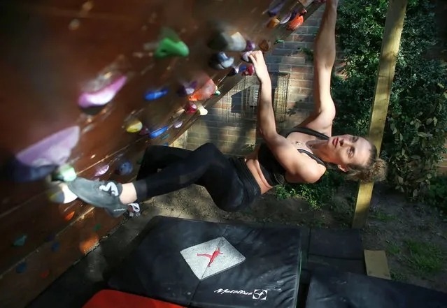 Team GB climber Imogen Horrocks trains on a climbing wall she built in her garden at her parents' home, following the outbreak of the coronavirus disease (COVID-19), Bordon, Britain, May 14, 2020. With Britain in lockdown to curb the spread of the novel coronavirus and no access to gyms and training facilities, Horrocks has used innovative ways to stay in shape. “I guess a lot of bodyweight training and different kinds of mobility exercises. Slacklining is a popular thing climbers do. We have different fingerboards and boards they hang over branches and a lot of floor work”, she added. (Photo by Tom Jacobs/Reuters)
