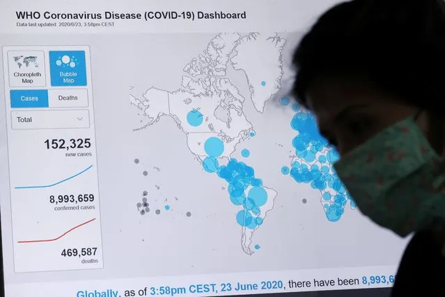 An employee from Sao Paulo state government works near a screen showing World Health Organization (WHO) dashboard about the coronavirus disease (COVID-19) outbreak around the world at a “Crisis Office”, set up to monitor social isolation and health information in Sao Paulo, Brazil, June 23, 2020. (Photo by Amanda Perobelli/Reuters)