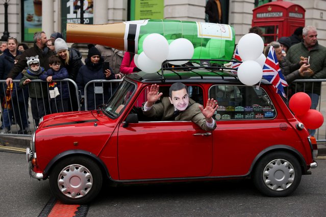 A person wearing a mask depicting Mr. Bean drives a car during the London's New Year's Day Parade event in London, Britain on January 1, 2024. (Photo by Hollie Adams/Reuters)