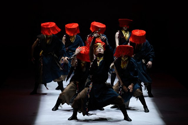Artists perform during a show to showcase creations from the “BODPASHOW.Join Hands in Labrang” collection during the China Fashion week in Beijing on March 28, 2025. (Photo by Wang Zhao/AFP Photo)
