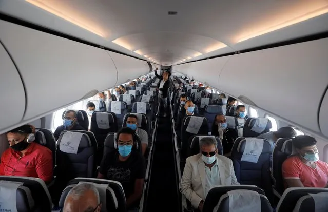 Travellers wear protective face masks on a plane, following an outbreak of the coronavirus disease (COVID-19), at Cairo International Airport in Cairo, Egypt, June 18, 2020. (Photo by Mohamed Abd El Ghany/Reuters)