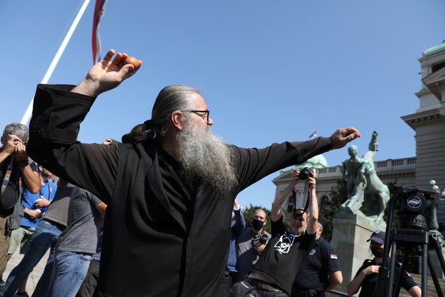 A protester throws an egg towards the Serbian parliament during an anti-government rally, as deputies attend the first session of the National Assembly after June's national election, amid the spread of the coronavirus disease (COVID-19) in Belgrade, Serbia, August 3, 2020. (Photo by Djordje Kojadinovic/Reuters)