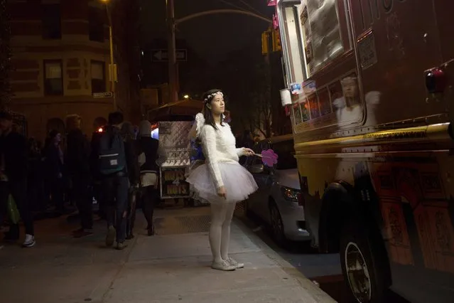Bonnie Chan waited at a food truck during the 41st Annual Village Halloween Parade October 31, 2014 in New York City. (Photo by Kevin Hagen/Getty Images)