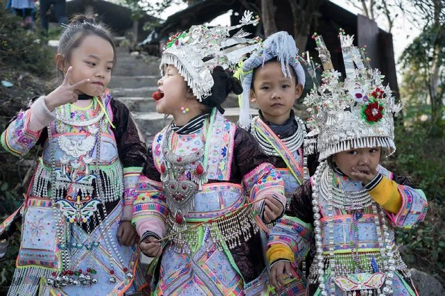 Girls from the Miao ethnic group dress up in ethnic costumes to celebrate the traditional Lusheng Festival on December 12, 2022 in Congjiang County, Qiandongnan Miao and Dong Autonomous Prefecture, Guizhou Province of China. (Photo by Mo Xiaoshu/VCG via Getty Images)