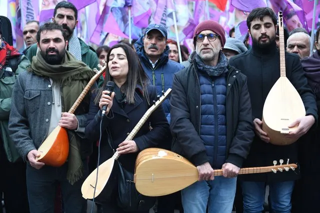 A protester sings as she takes part in a demonstration to pay tribute to the Enghien Street shooting victims in Paris on December 23, 2022, and to support the Kurdish community in Paris on December 28, 2022. A 69-year-old French man suspected of killing three Kurds and injuring three others in a Paris shooting has confessed to a “pathological” hatred for foreigners, Paris prosecutor Laure Beccuau said on December 25, 2022. The suspect spent nearly a day in a psychiatric facility on December 25, before being returned to police custody on the same day. (Photo by Firas Abdullah/AFP Photo)