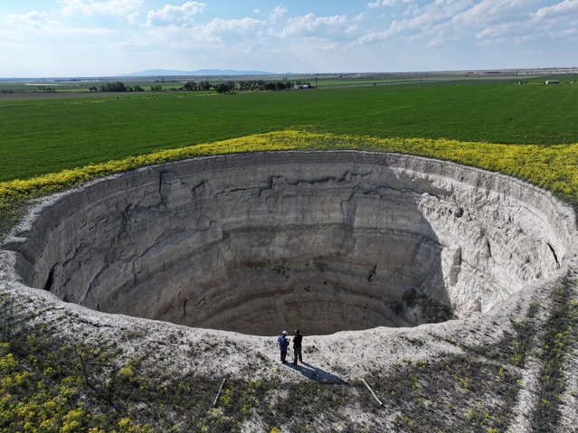 A view of Yarimoglu sinkhole (obruk), caused by some form of collapse of the surface layer in 2009, in Konya province, Turkiye on May 15, 2025. The gigantic pit formed between the fields where intensive irrigation activities are carried out is expanding and growing every year. (Photo by Abdullah Dogan/Anadolu via Getty Images)