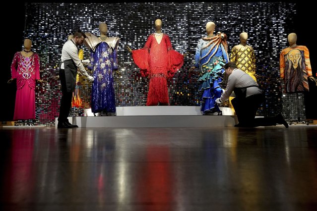 Art handlers arrange costumes during a photo opportunity ahead of the Barry Humphries: The Personal Collection sale at Christie's auction rooms in London, Friday, February 7, 2025. Items belonging to the late Australian comedian are to be auctioned Feb. 13 in a sale estimated at 2 million to 4 million pounds ($2.49 million to $4.98 million). (Photo by Kirsty Wigglesworth/AP Photo)