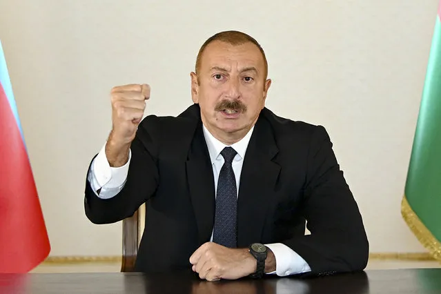 In this photo provided by the Azerbaijan's Presidential Press Office provided on Sunday, September 27, 2020, Azerbaijani President Ilham Aliyev gestures as he addresses the nation in Baku, Azerbaijan. Fighting between Armenia and Azerbaijan broke out Sunday around the separatist region of Nagorno-Karabakh and the Armenian Defense Ministry said two Azerbaijani helicopters were shot down. Ministry spokeswoman Shushan Stepanyan also said Armenian forces hit three Azerbaijani tanks. (Photo by Azerbaijani Presidential Press Office via AP Photo)