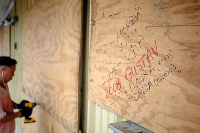 Bang Bui prepares his business Handy Mart as Hurricane Delta approaches in Abbeville, Louisiana, U.S., October 8, 2020. (Photo by Kathleen Flynn/Reuters)