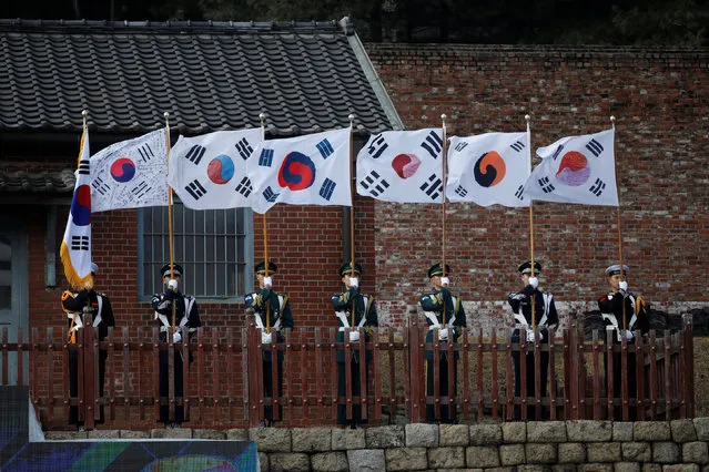 South Korean honor guards hold national flags during a ceremony celebrating the 99th anniversary of the March First Independence Movement against Japanese colonial rule, at Seodaemun Prison History Hall in Seoul, South Korea, March 1, 2018. (Photo by Kim Hong-Ji/Reuters)