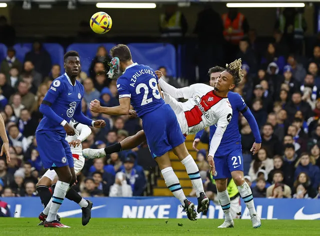 Chelsea's Spanish defender Cesar Azpilicueta (centre left) is hurt when kicked by Southampton's French striker Sekou Mara (2R) attempting this overhead kick during the English Premier League football match between Chelsea and Southampton at Stamford Bridge in London on February 18, 2023. (Photo by Andrew Boyers/Action Images via Reuters)