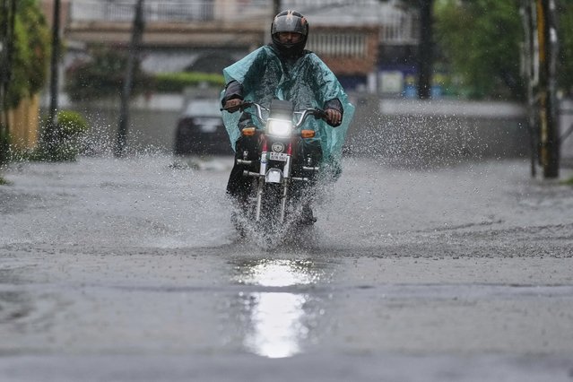 A motorcyclist rides through a flooded road during monsoon rainfall, in Rawalpindi, Pakistan, Thursday, July 17, 2025. (Photo by Anjum Naveed/AP Photo)