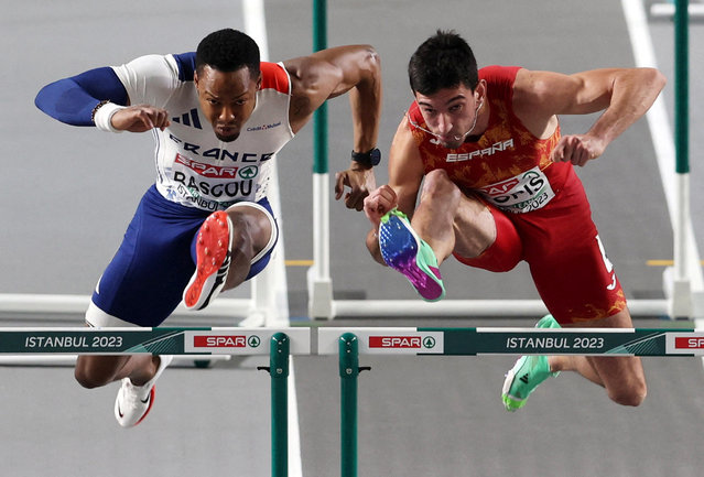 French athlete Dimitri Bascou and Spain's Enrique Llopis compete in the men's 60-metre hurdles at the European Athletics Indoor Championships in Istanbul on March 4, 2023. (Photo by Umit Bektas/Reuters)