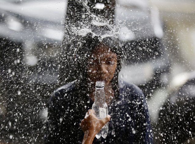 Children play during a downpour in Las Pinas City, Metro Manila, Philippines, 23 July 2025. According to the National Disaster Risk Reduction and Management Council (NDRRMC), multiple cities and municipalities across the country have declared a state of calamity after storm Wipha caused consecutive days of monsoon rain. (Photo by Francis R. Malasig/EPA)