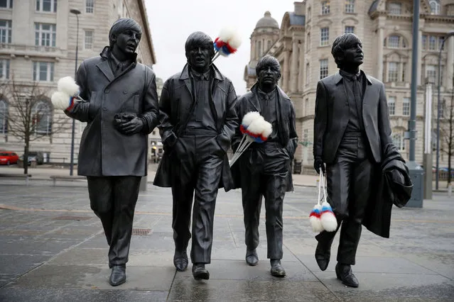 A statue of The Beatles sports “tickling sticks”, comedian Ken Dodd's quintessential prop, ahead of Dodd's funeral in his home town of Liverpool, Britain, March 28, 2018. (Photo by Phil Noble/Reuters)