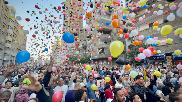 Worshippers hold balloons after the Eid al-Fitr prayer on Sidi Bishr Street in Alexandria, Egypt, on March 31, 2025. (Photo by Ayman Aref/NurPhoto/Rex Features/Shutterstock)