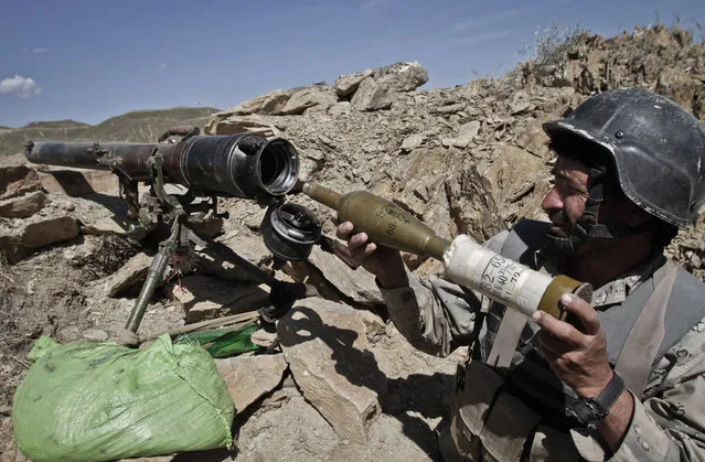An Afghan border policeman arms a rocket launcher on his position at the border between Afghanistan and Pakistan in Goshta district of Jalalabad province east of Kabul, Afghanistan, Thursday, May 9, 2013. Afghan President Hamid Karzai on Thursday warned Pakistan against trying to force Afghanistan to accept as an international border the Durand line which separates the two countries. Border tensions between the two countries have escalated dramatically in the last two weeks with both sides accusing the other of unprovoked attacks. (Photo by Rahmat Gul/AP Photo)