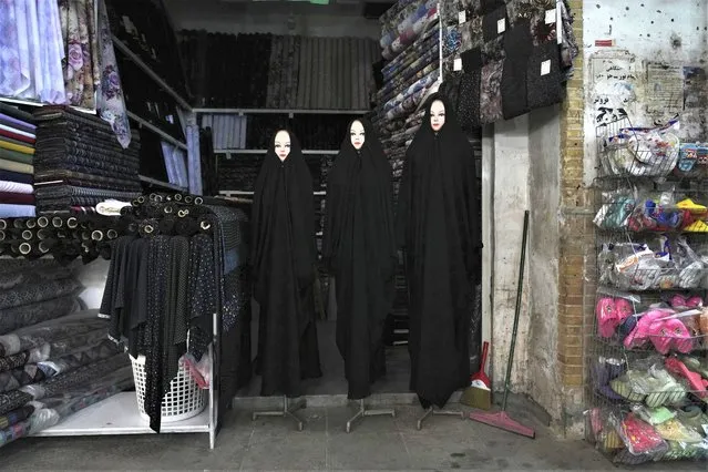 Mannequins dressed with Chador are displayed at a shop in an old grand bazaar at the city of Qom, some 80 miles (125 kilometers) south of the capital Tehran, Iran, Tuesday, February 7, 2023. (Photo by Vahid Salemi/AP Photo)