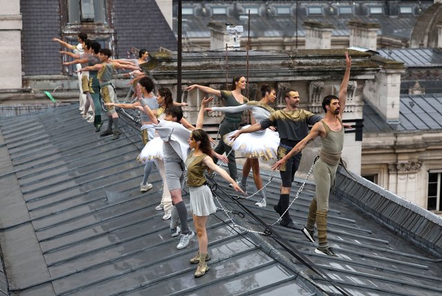 Dancers perform on a roof during the opening ceremony in Paris, France on July 26, 2024. (Photo by Dan Mullan/Reuters)