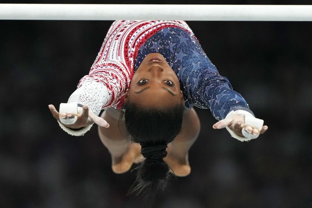 Simone Biles, of the United States, performs on the uneven bars during the women's artistic gymnastics team finals round at Bercy Arena at the 2024 Summer Olympics, Tuesday, July 30, 2024, in Paris, France. (Photo by Natacha Pisarenko/AP Photo)