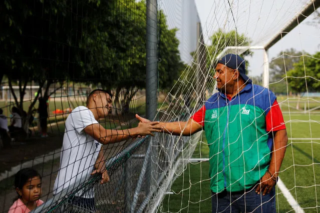 Former El Salvador National Soccer Team goalkeeper Ricardo Guevara Mora is greeted by a friend at El Cafetalon park in Santa Tecla, El Salvador on May 11, 2018. (Photo by Jose Cabezas/Reuters)