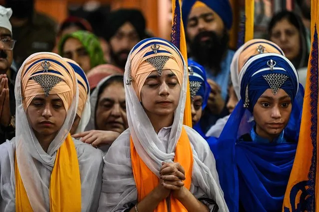 Sikh pilgrims pray at the Gurdwara Panja Sahib, one of Sikhism's most holy places, during the annual “Baisakhi” festival, a spring harvest festival for Sikhs and Hindus, in Hasan Abdal on April 14, 2023. (Photo by Aamir Qureshi/AFP Photo)