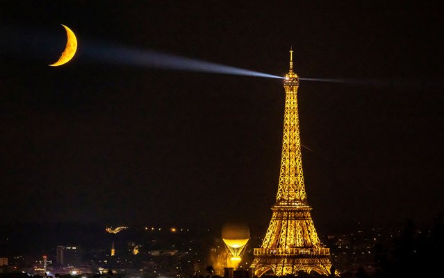 The moon is pictured with the Olympic cauldron and the Eiffel Tower in Paris, France on August 9, 2024. (Photo by Christian Hartmann/Reuters)