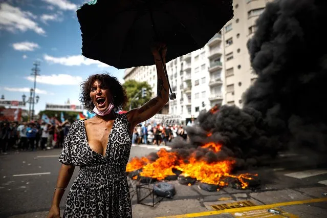 A demonstrator gestures during protests around the Argentine Parliament in Buenos Aires, Argentina, 10 March 2022. Serious disturbances were registered in the surroundings of the seat of the Argentine Parliament when demonstrators protesting against the new agreement with the International Monetary Fund (IMF) clashed with the police of the city of Buenos Aires. (Photo by Juan Ignacio Roncoroni/EPA/EFE)