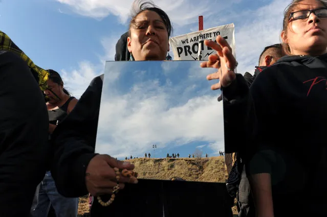 A protester holds up a mirror during a protest of the Dakota Access pipeline near the Standing Rock Indian Reservation near Cannon Ball, North Dakota November 6, 2016. (Photo by Stephanie Keith/Reuters)