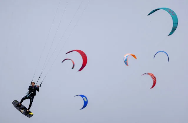 A kite surfer practices the sport along the North Sea beach of the Brouwersdam, in Scharendijke, on May 21, 2023. (Photo by Robin van Lonkhuijsen/ANP via AFP Photo)
