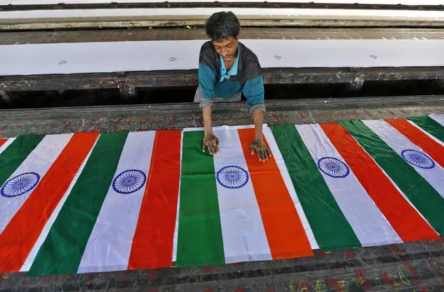 A worker makes Indian national flags at a workshop ahead of Republic Day celebrations in the western Indian city of Ahmedabad January 23, 2015. (Photo by Amit Dave/Reuters)