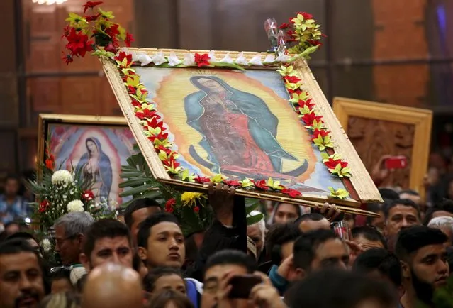 Pilgrims hold up images of the Virgin of Guadalupe during an annual pilgrimage in honor of the Virgin, the patron saint of Mexican Catholics, at the Cathedral of Ciudad Juarez, Mexico December 12, 2015. (Photo by Jose Luis Gonzalez/Reuters)