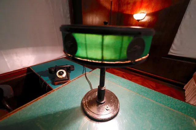 A lamp sits next to a telephone on a desk inside Stalin's Bunker in Samara, Russia, on Tuesday, June 26, 2018. (Photo by David Gray/Reuters)