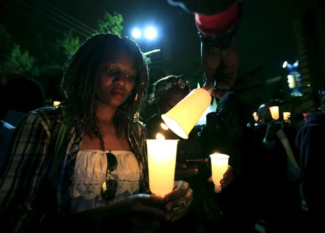 People light candles during a street concert organized to highlight the situation in Burundi by PAWA254, an activist organization, in Kenya's capital Nairobi December 20, 2015. (Photo by Noor Khamis/Reuters)