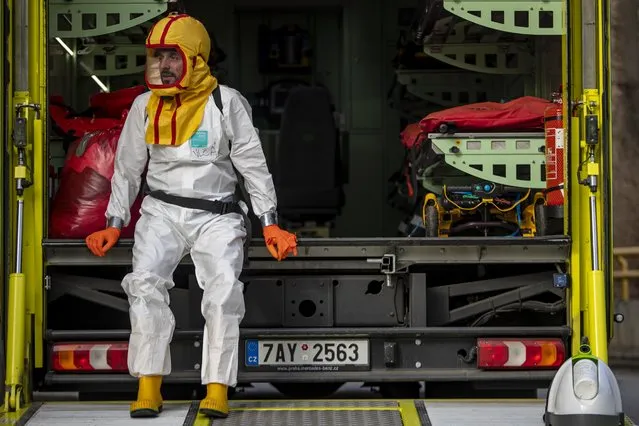 A healthcare worker from Prague Ambulance Service rests after transport of COVID-19 patients to Semily Hospital from overloaded Ceska Lipa Hospital, in Semily, Czech Republic, 18 March 2021. Hospitals across the country are on the edge of capacity and so it is necessary to transport COVID-19 positive patients to hospitals with free capacity. According to the data of Czech Health Ministry of 17 March 2021, there are about 8900 patients with Covid in the Czech hospitals, of which about 1900 on ICU. The Czech Republic's increasing trend in new SARS-CoV-2 infections is still high as Czech government announced from 01 March 2021 tightened measures, to curb the spread of COVID-19 caused by the SARS-CoV-2. (Photo by Martin Divisek/EPA/EFE)